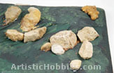 Placing and gluing rocks od dioram base